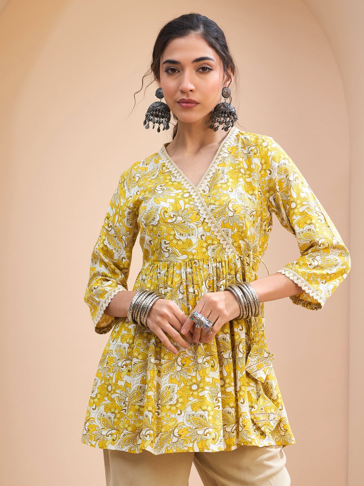 Women's Women Yellow Floral Wrap Neck Peplum Kurti in Rayon by Shae for wholesale, bulk, supplier, manufacturer and wholesaler buyers from Trendphoria