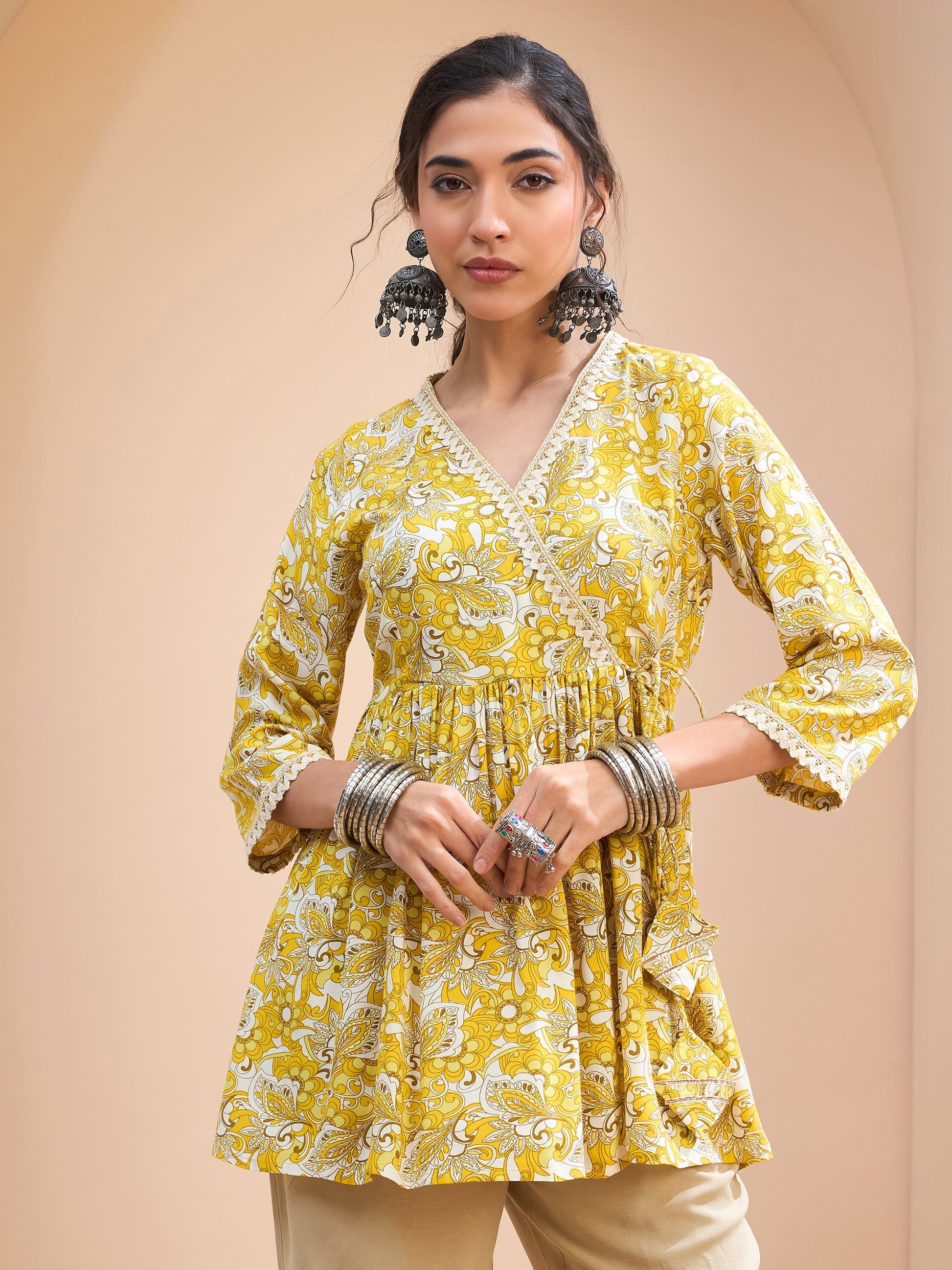 Women's Women Yellow Floral Wrap Neck Peplum Kurti in Rayon by Shae for wholesale, bulk, supplier, manufacturer and wholesaler buyers from Trendphoria