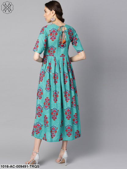 Turqish Blue Color Printed Half Sleeve Pleated Maxi Dress With Deep Back And Tassel Detailing.