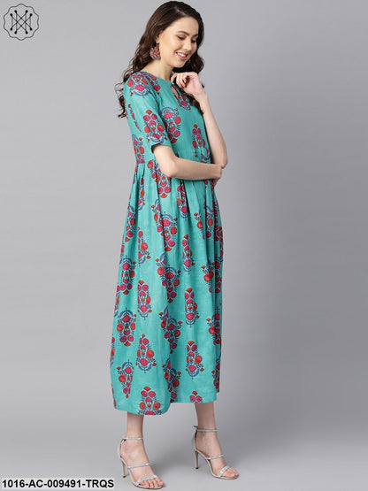 Turqish Blue Color Printed Half Sleeve Pleated Maxi Dress With Deep Back And Tassel Detailing.