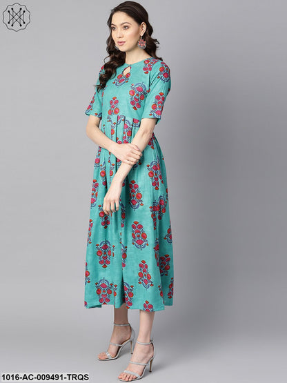 Turqish Blue Color Printed Half Sleeve Pleated Maxi Dress With Deep Back And Tassel Detailing.